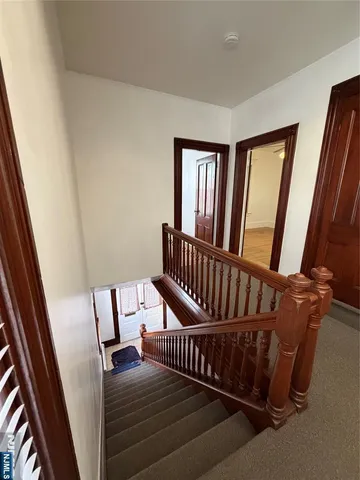 a view of staircase with furniture and a window