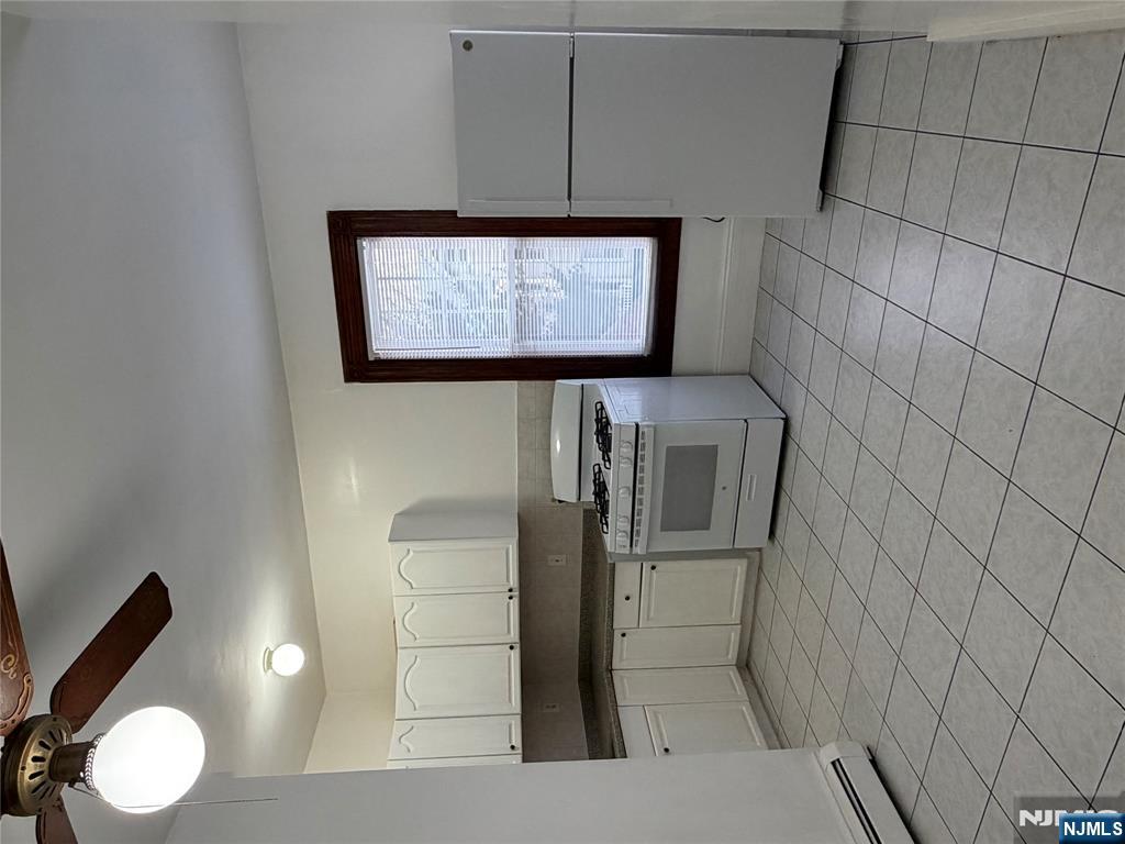 64 Knickerbocker Road, Unit 2 2 Englewood, NJ 07631 - Photo 4 of 27 a kitchen with stainless steel appliances granite countertop a stove a sink and a refrigerator