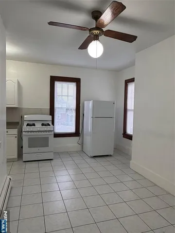 a kitchen with a cabinets and white appliances