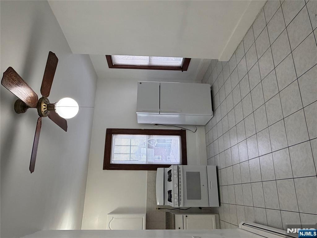 64 Knickerbocker Road, Unit 2 2 Englewood, NJ 07631 - Photo 5 of 27 a kitchen with a cabinets and white appliances