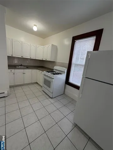 a kitchen with a sink a stove and cabinets