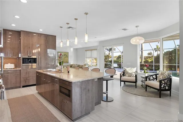 a kitchen with cabinets and chairs