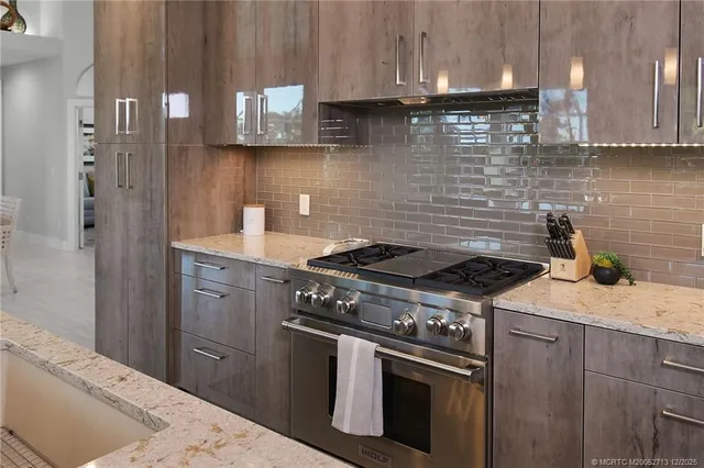 a large kitchen with lots of counter space and furniture