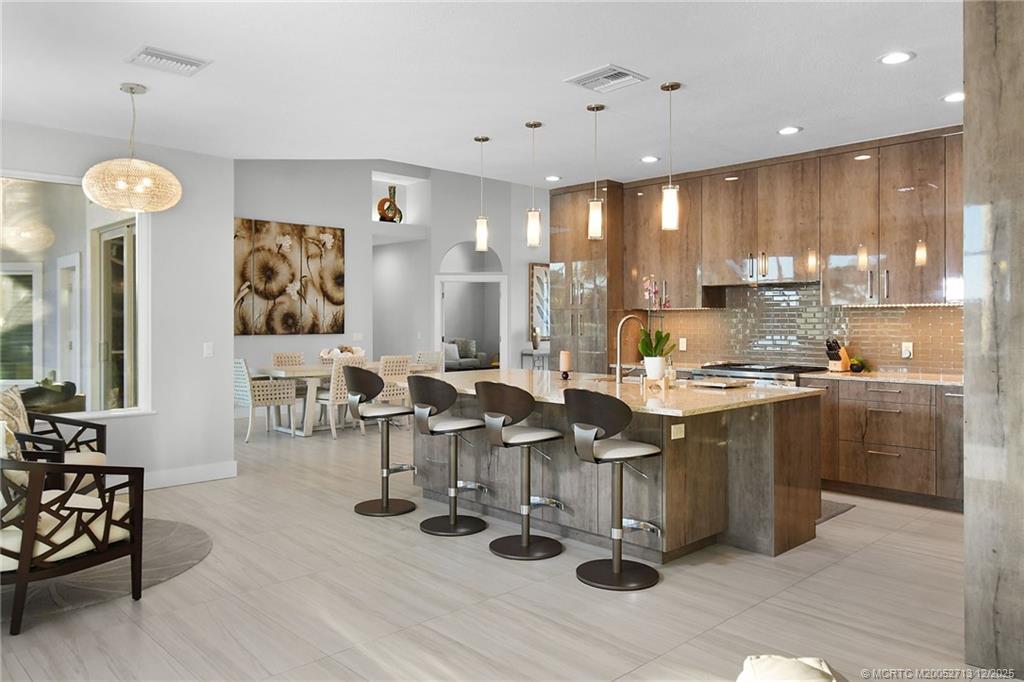 8149 Southeast Double Tree Drive Hobe Sound, FL 33455 - Photo 17 of 61 a large kitchen with lots of counter space and furniture