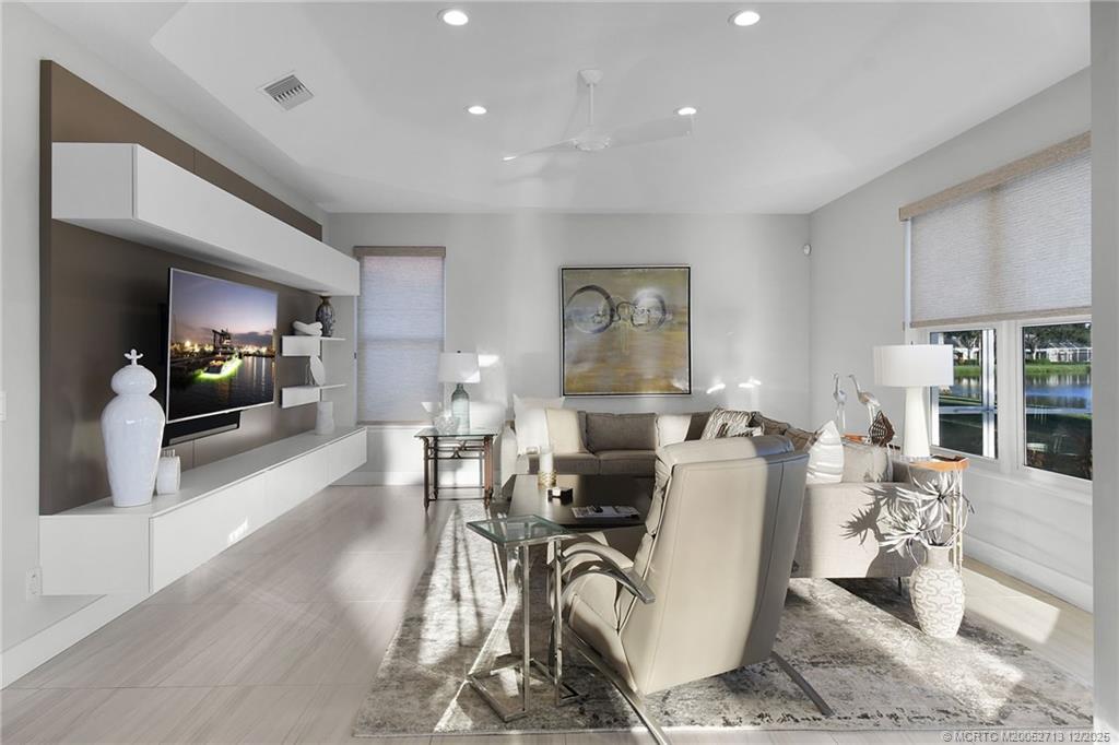 8149 Southeast Double Tree Drive Hobe Sound, FL 33455 - Photo 20 of 61 a living room with furniture a wooden floor and a flat screen tv
