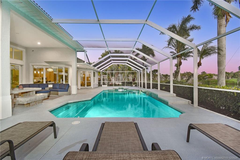 8149 Southeast Double Tree Drive Hobe Sound, FL 33455 - Photo 2 of 61 a swimming pool with outdoor seating