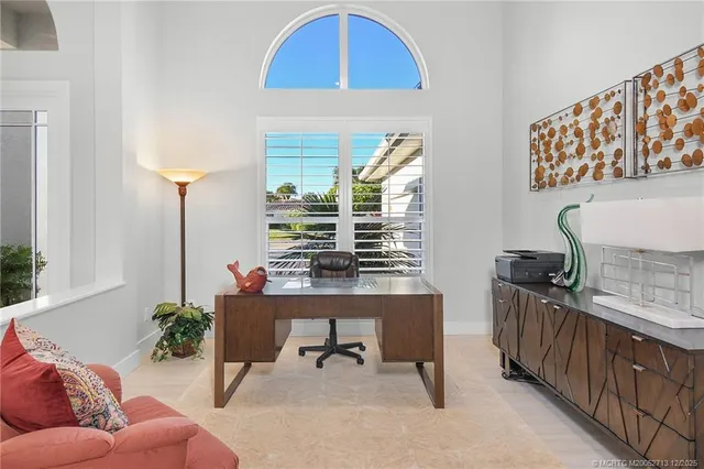 a spacious bathroom with a granite countertop sink a toilet a mirror and shower