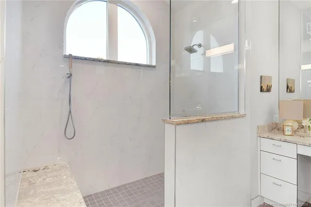 a bedroom with two beds and painting on the wall