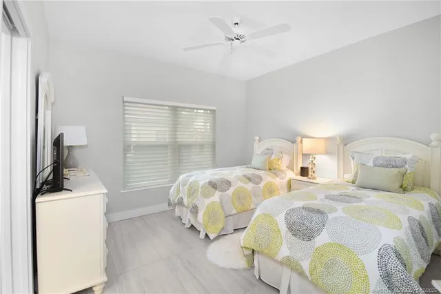 a living room with furniture a flat screen tv and entryway