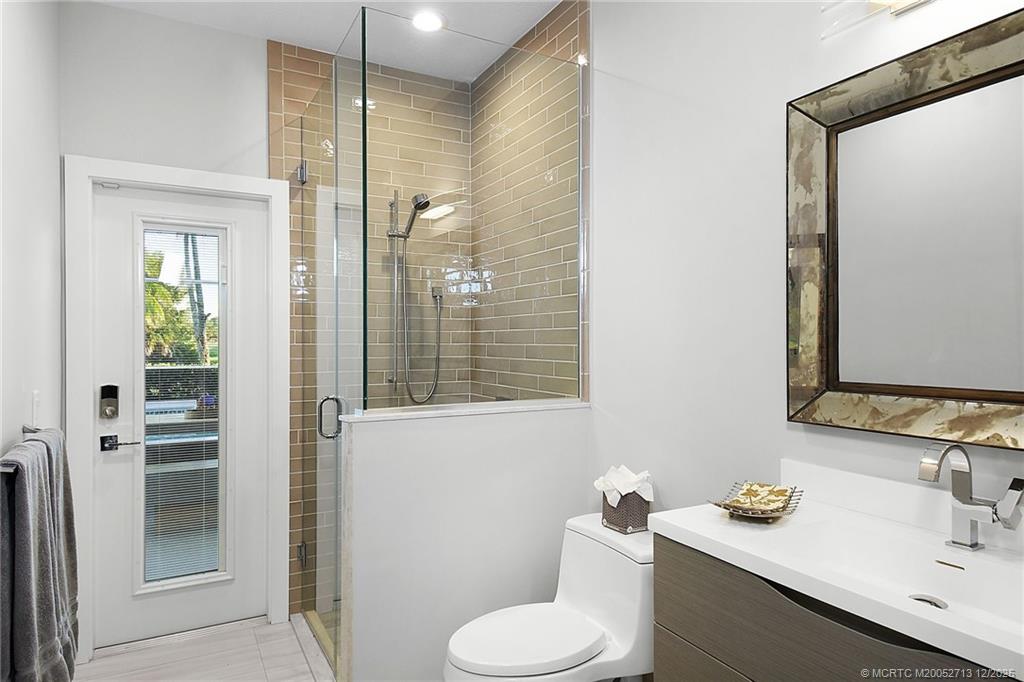 8149 Southeast Double Tree Drive Hobe Sound, FL 33455 - Photo 35 of 61 a bathroom with a sink toilet and shower