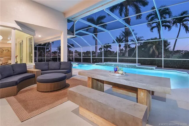 a view of a house with a yard and palm trees