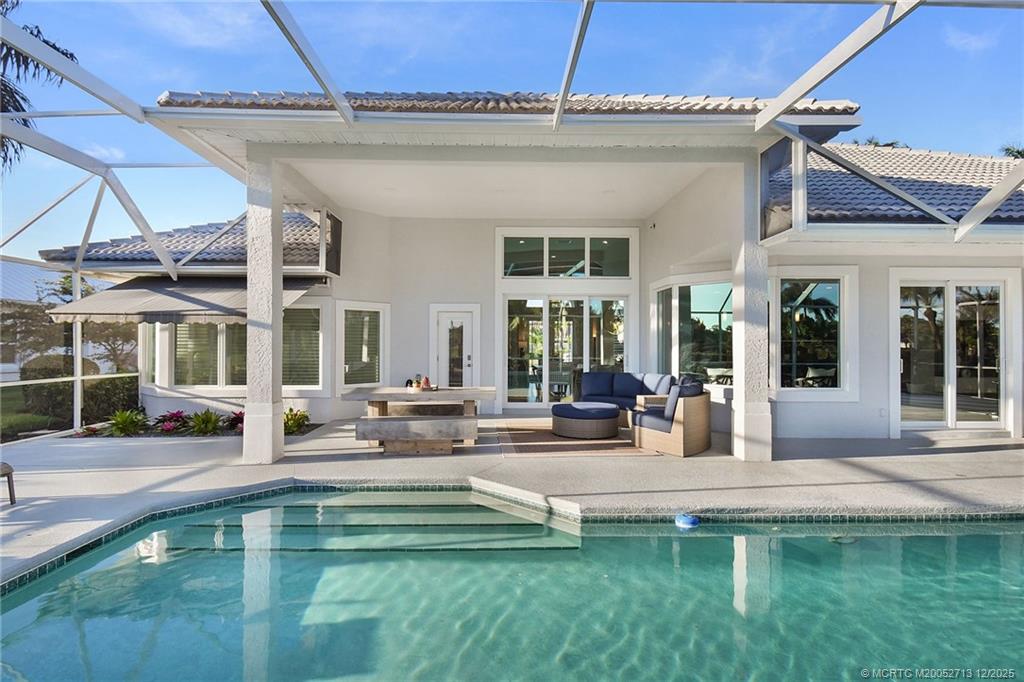 8149 Southeast Double Tree Drive Hobe Sound, FL 33455 - Photo 42 of 61 a view of a house with swimming pool and sitting area