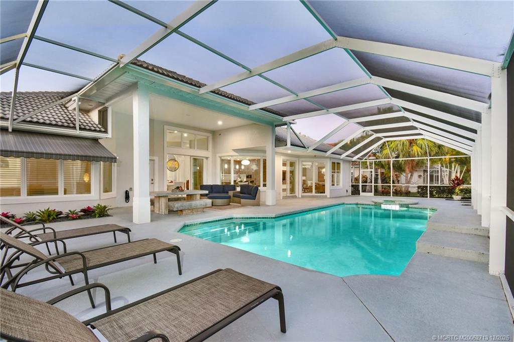 8149 Southeast Double Tree Drive Hobe Sound, FL 33455 - Photo 43 of 61 a view of a house with swimming pool and sitting area