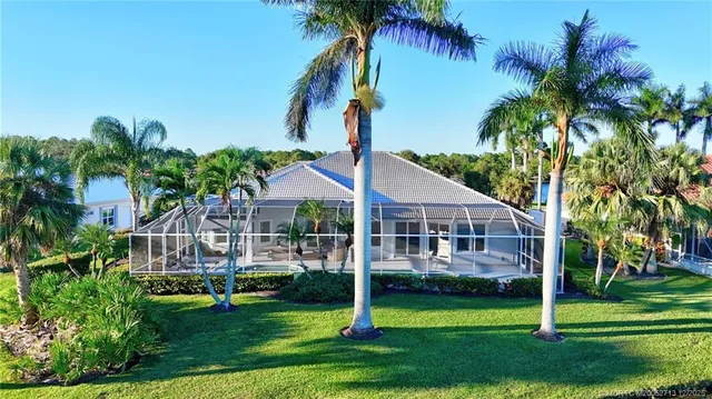 a front view of a house with a garden and plants