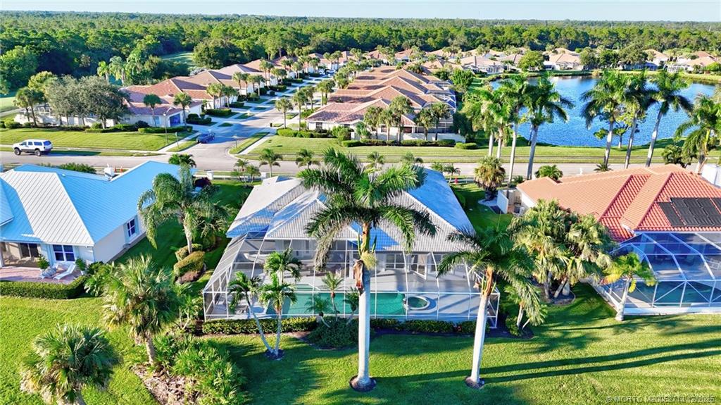 8149 Southeast Double Tree Drive Hobe Sound, FL 33455 - Photo 47 of 61 an aerial view of residential houses with outdoor space and trees
