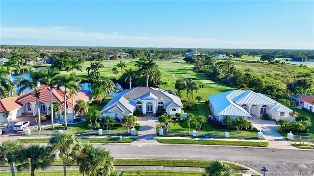 an aerial view of a house with garden space and lake view