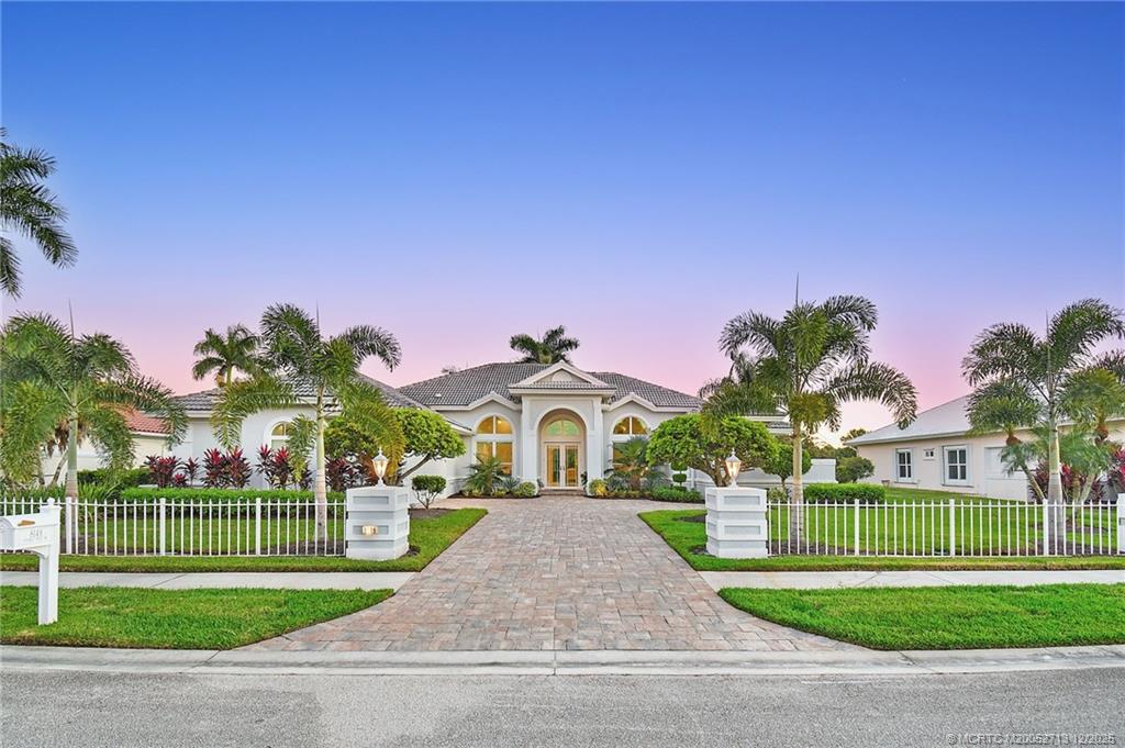 8149 Southeast Double Tree Drive Hobe Sound, FL 33455 - Photo 5 of 61 a front view of a house with a yard and potted plants