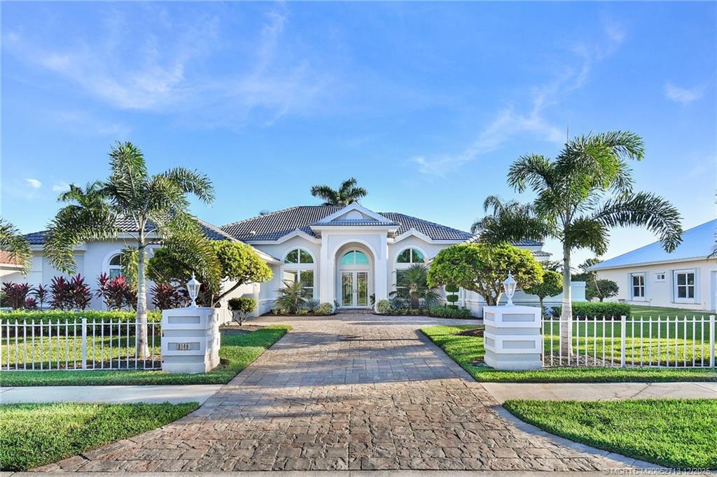8149 Southeast Double Tree Drive Hobe Sound, FL 33455 - Photo 58 of 61 a front view of a house with a yard