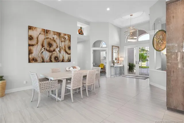 a large white kitchen with a large window and stainless steel appliances