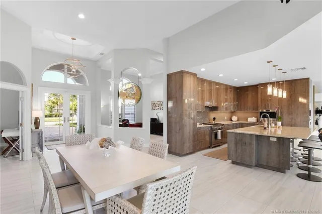 a kitchen with a sink a refrigerator and cabinets