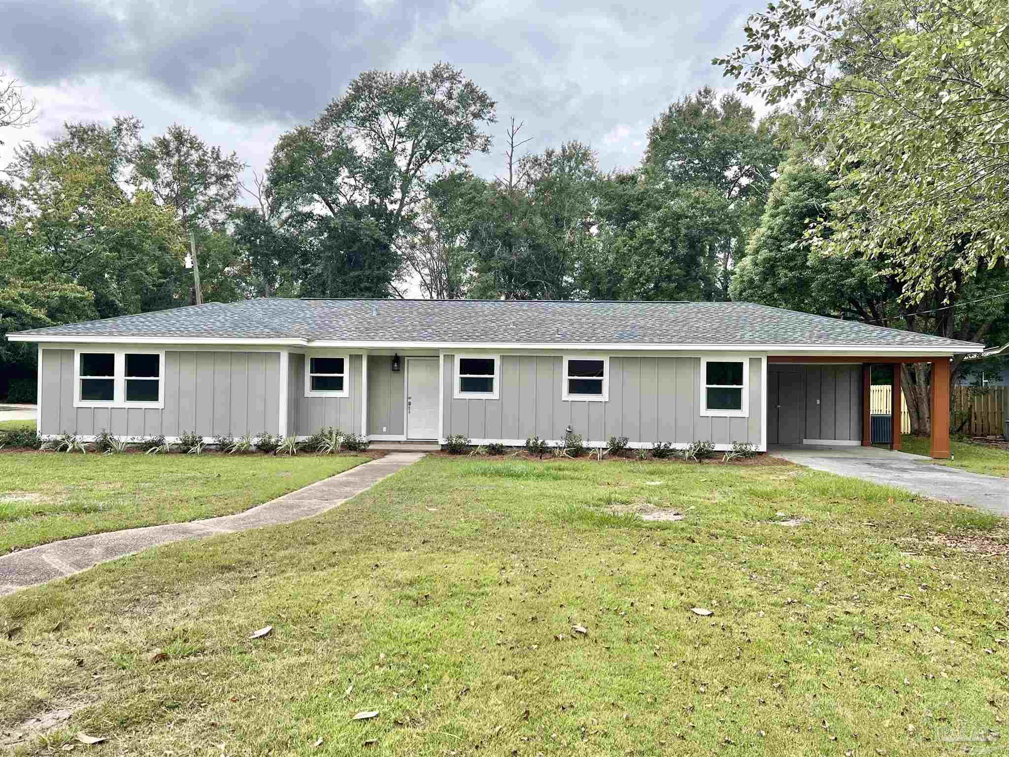 618 South Carney Street Atmore, AL 36502 - Photo 1 of 39 a view of a yard in front of a house with a large tree
