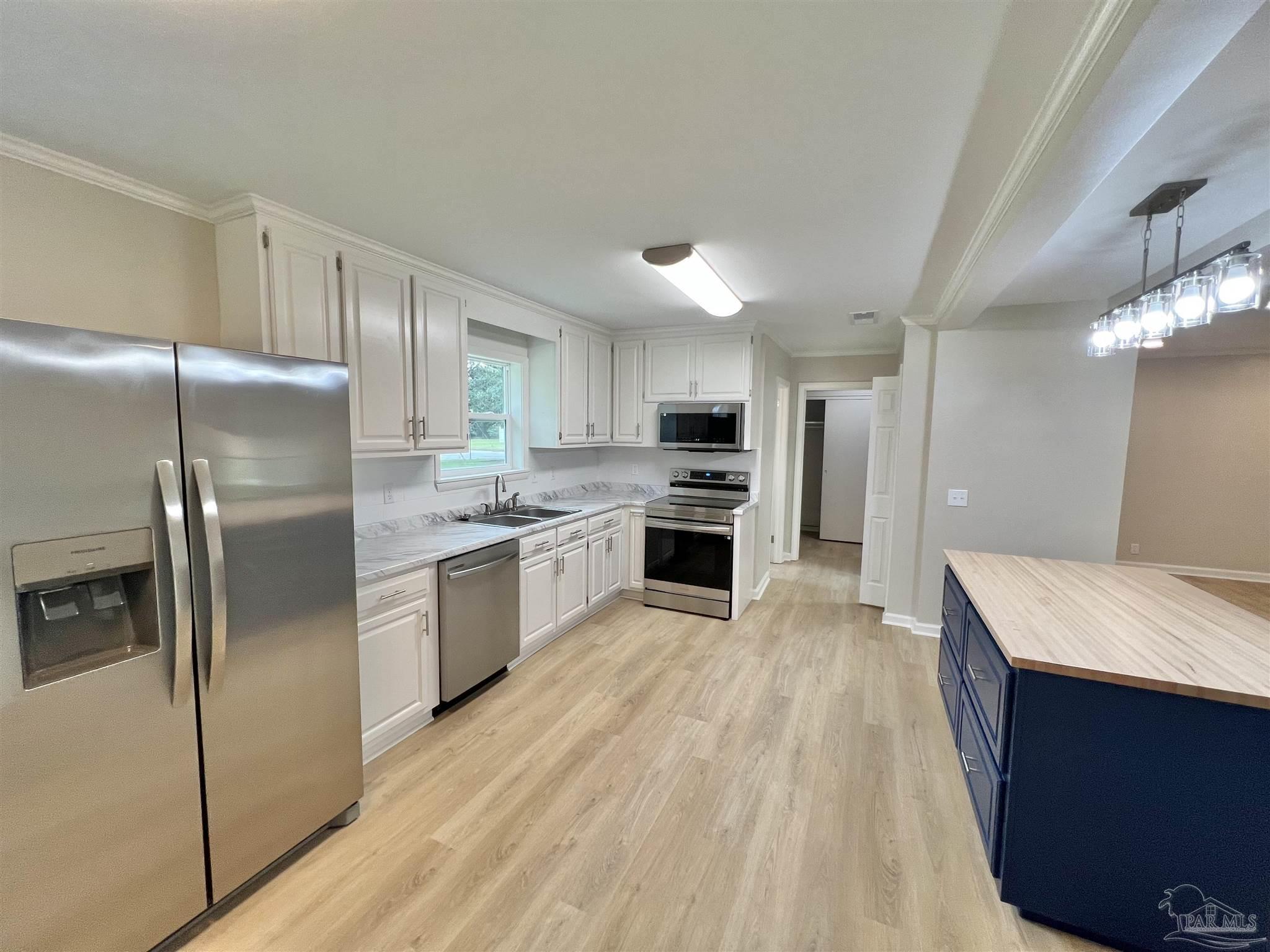 618 South Carney Street Atmore, AL 36502 - Photo 12 of 39 a view of kitchen with wooden floor