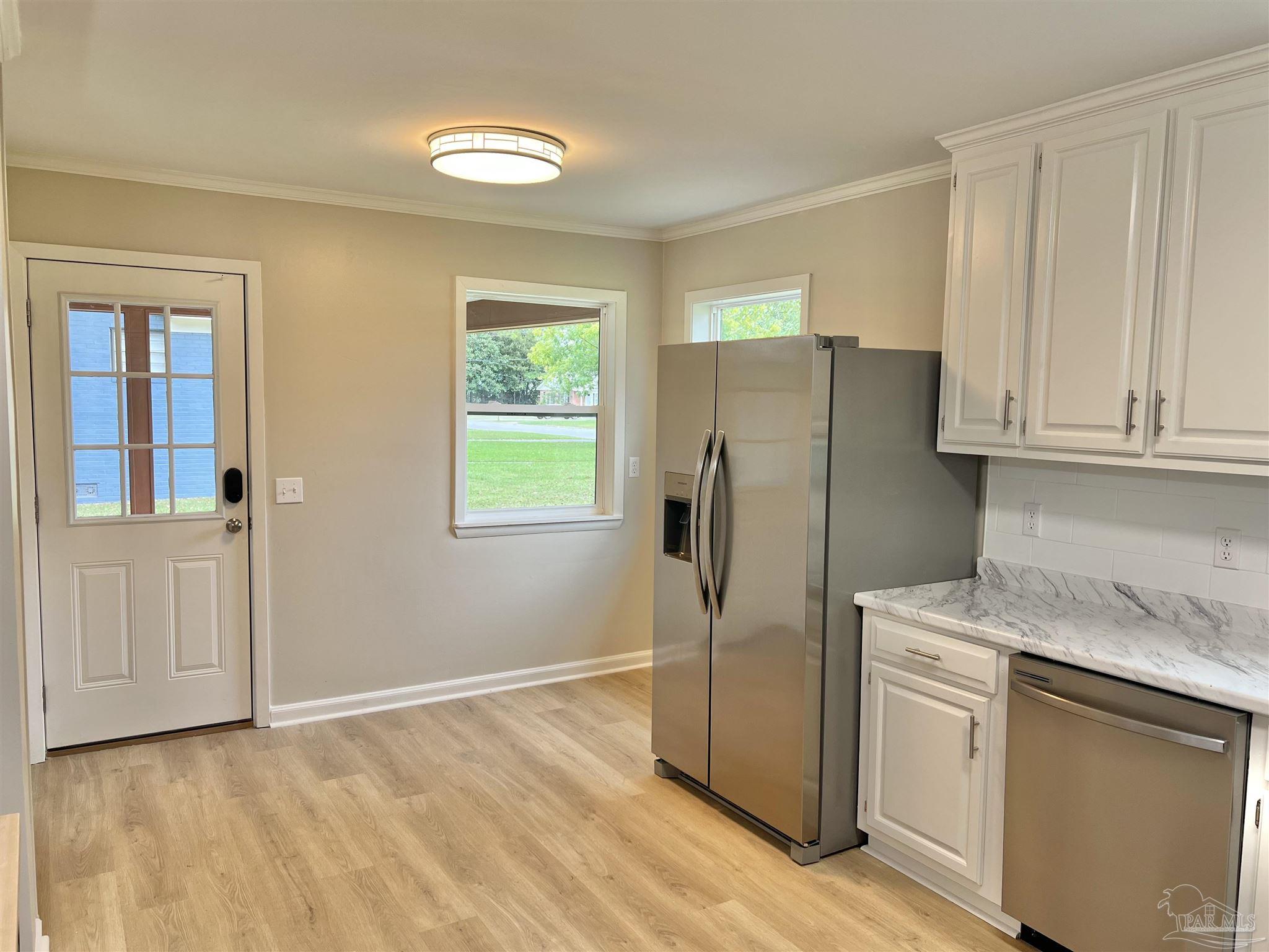 618 South Carney Street Atmore, AL 36502 - Photo 14 of 39 a kitchen with stainless steel appliances granite countertop a refrigerator and a stove top oven