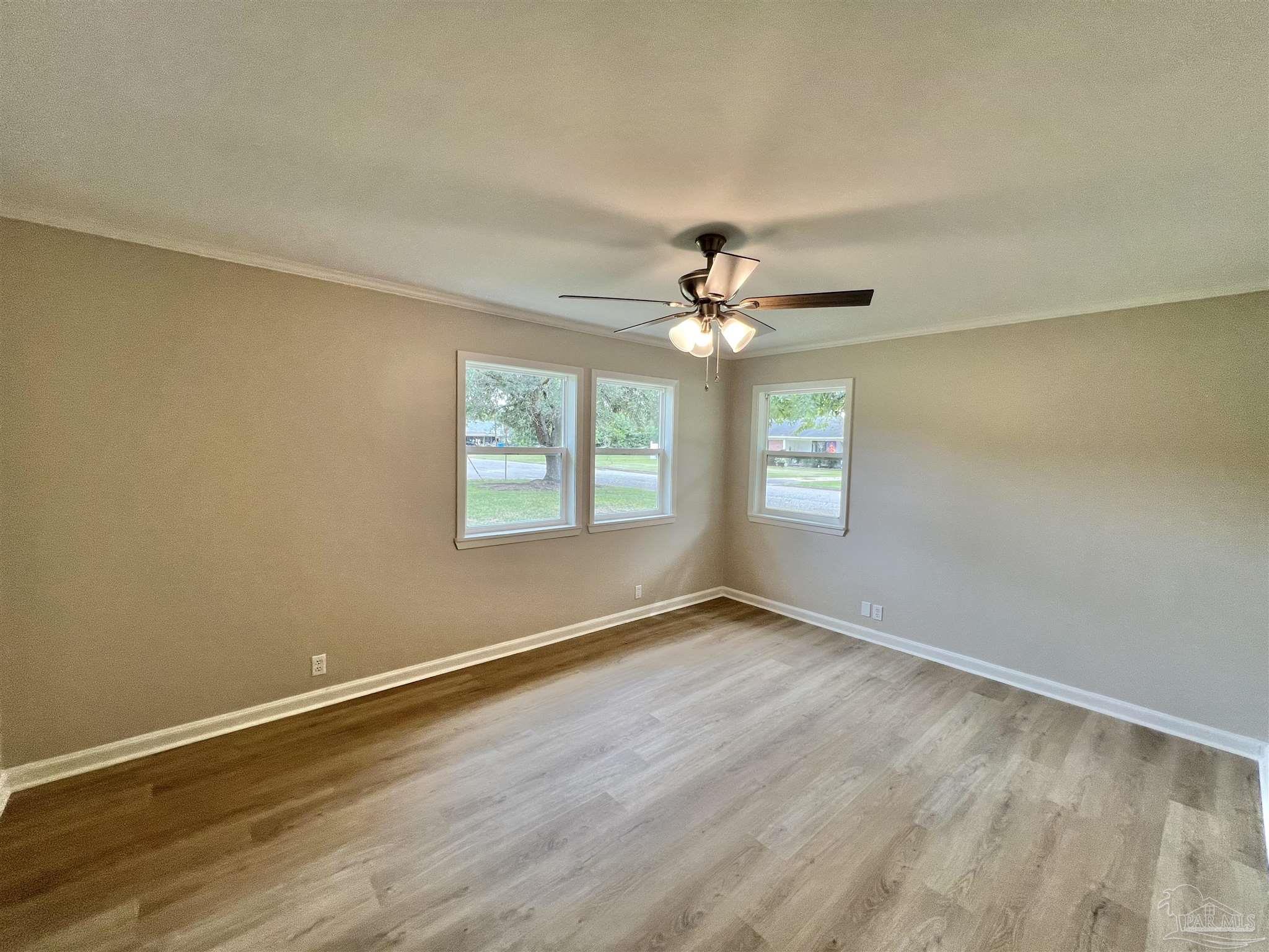 618 South Carney Street Atmore, AL 36502 - Photo 18 of 39 a view of an empty room with wooden floor and a window