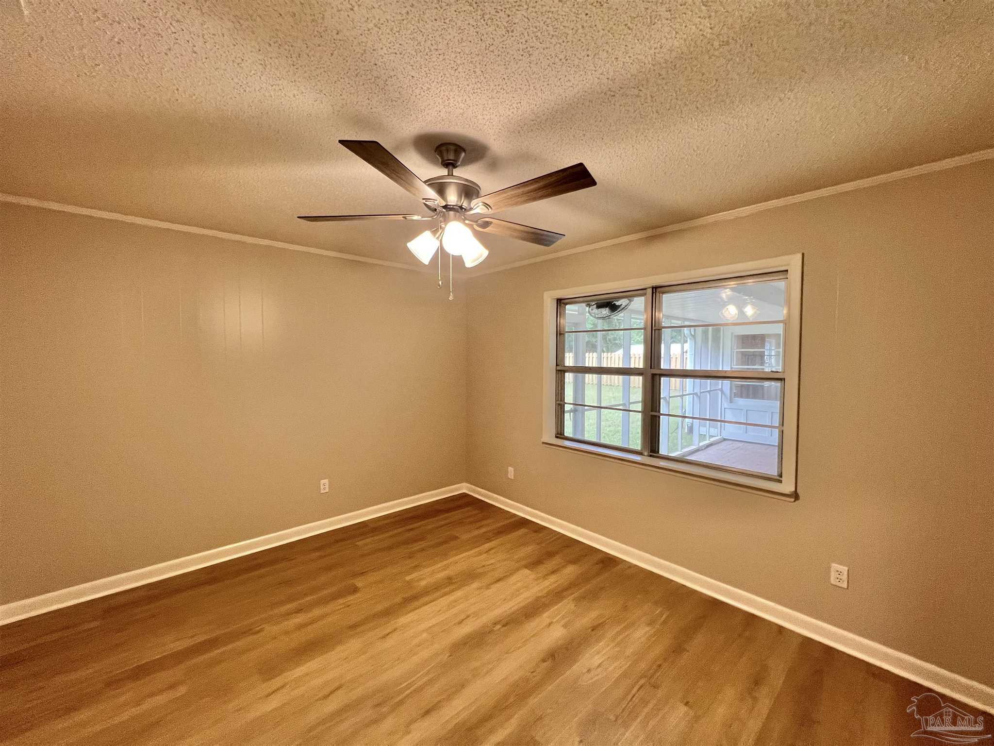 618 South Carney Street Atmore, AL 36502 - Photo 22 of 39 a view of an empty room with a window and a ceiling fan