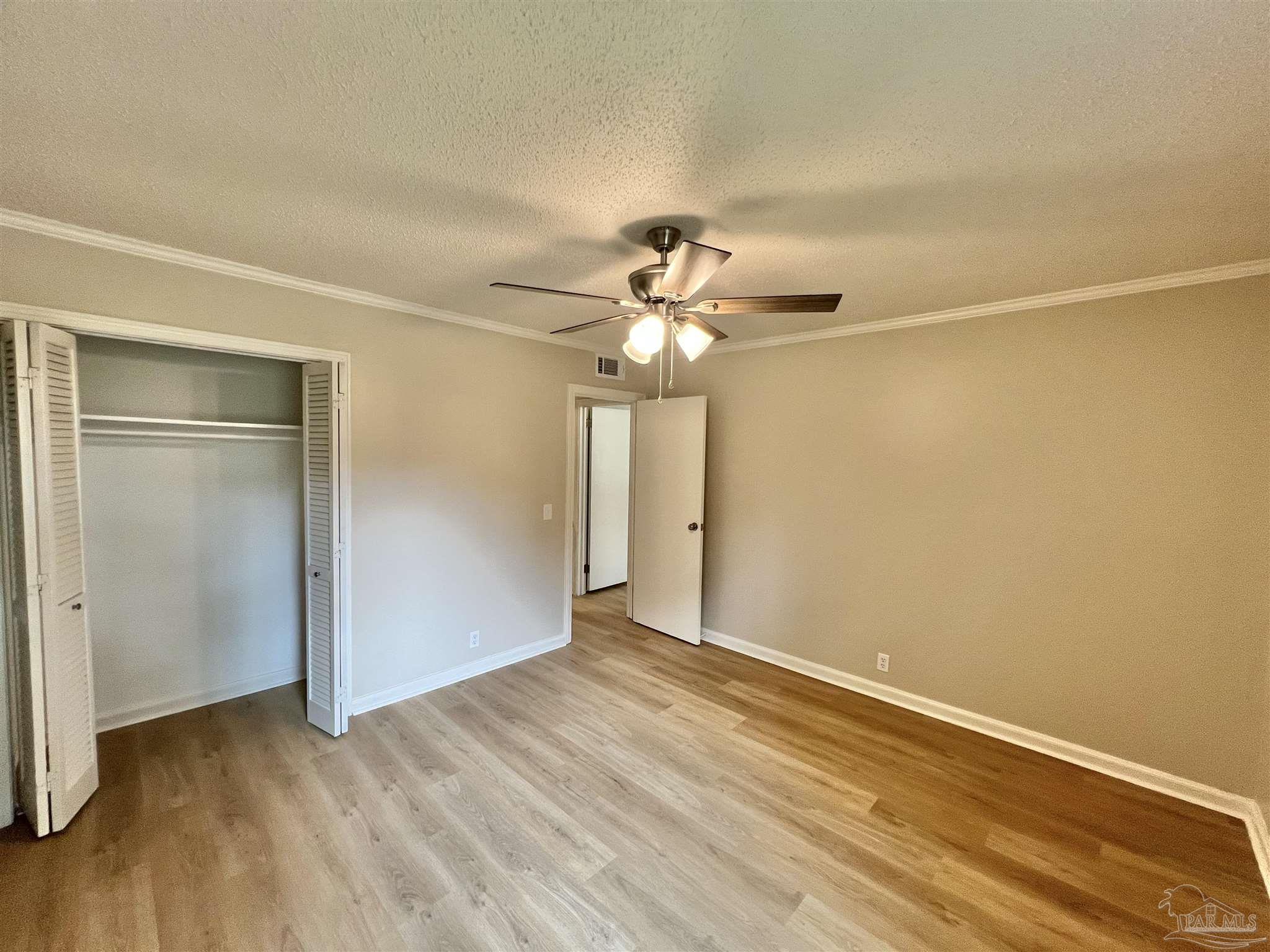 618 South Carney Street Atmore, AL 36502 - Photo 23 of 39 a view of a room with wooden floor closet and a ceiling fan