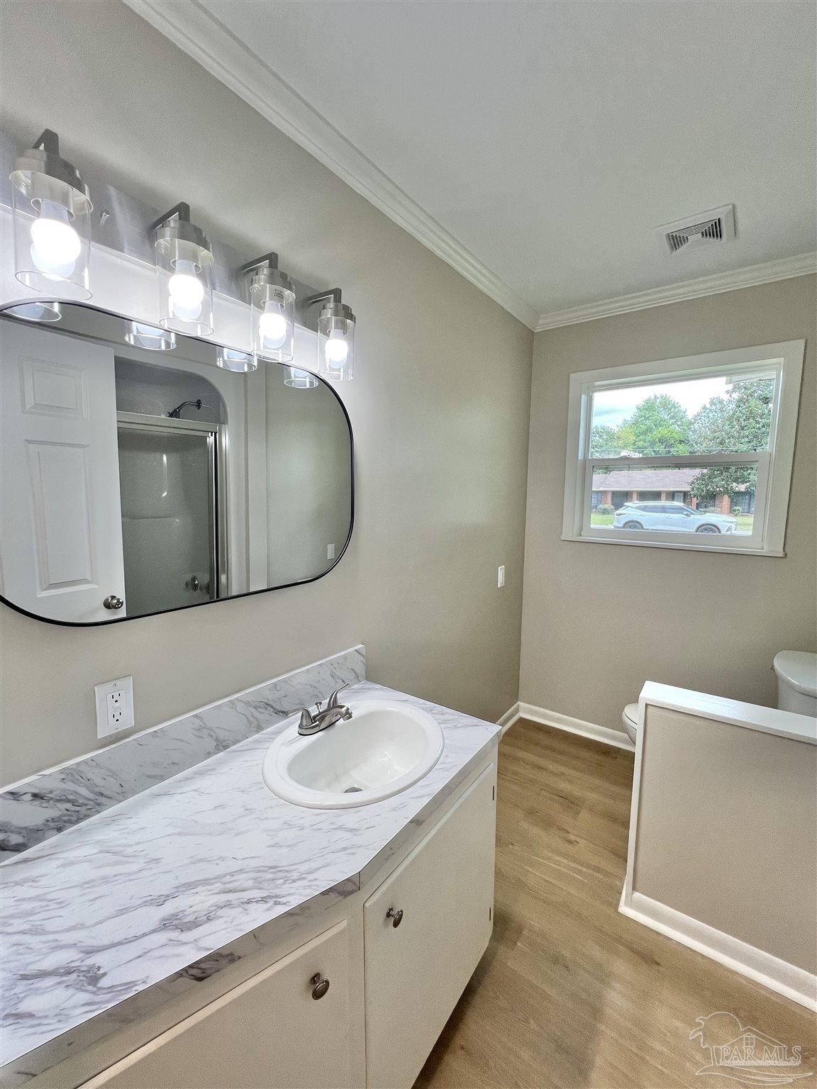 618 South Carney Street Atmore, AL 36502 - Photo 29 of 39 a bathroom with a double vanity sink and a mirror