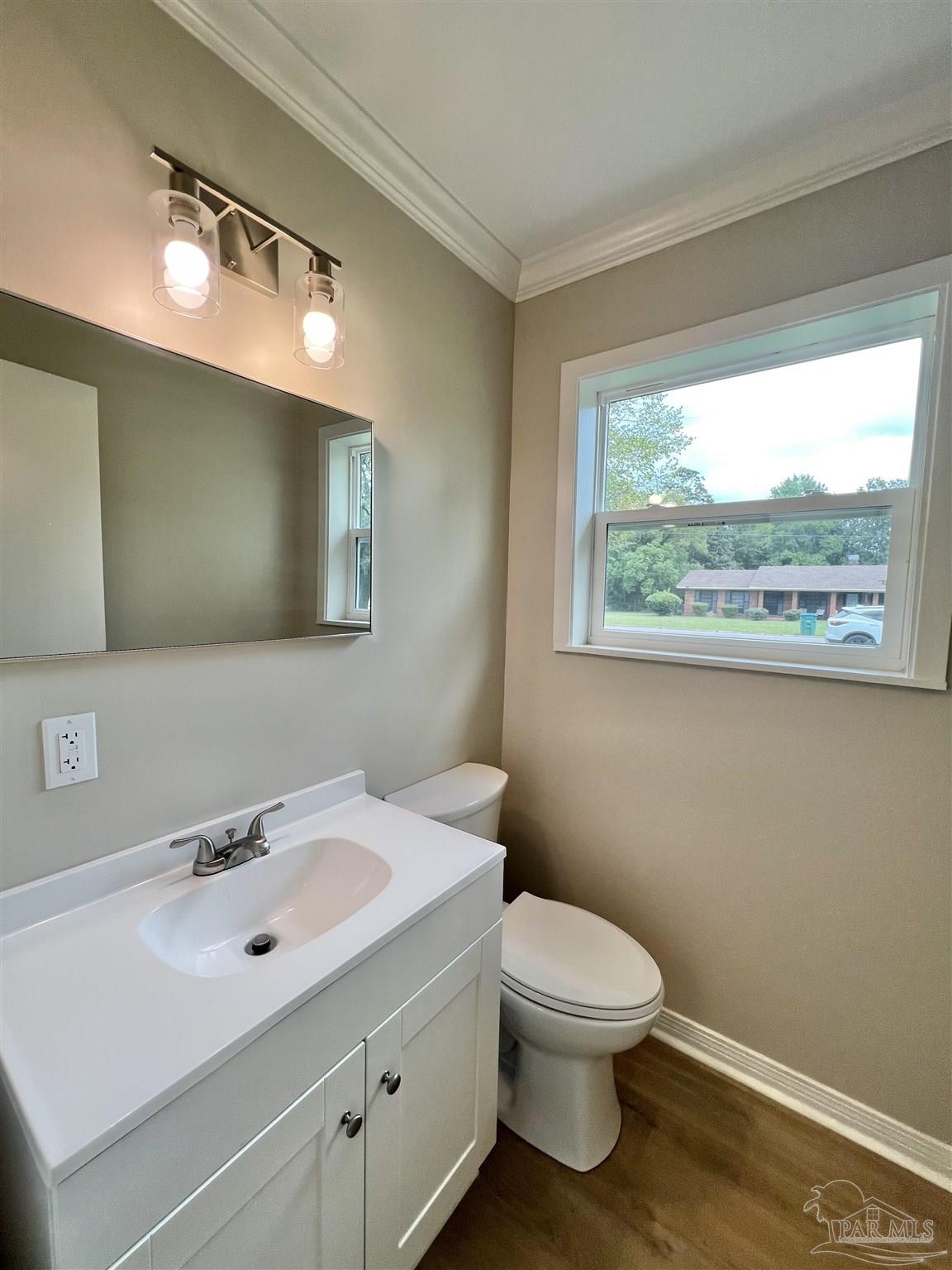 618 South Carney Street Atmore, AL 36502 - Photo 33 of 39 a bathroom with a toilet a sink and a mirror