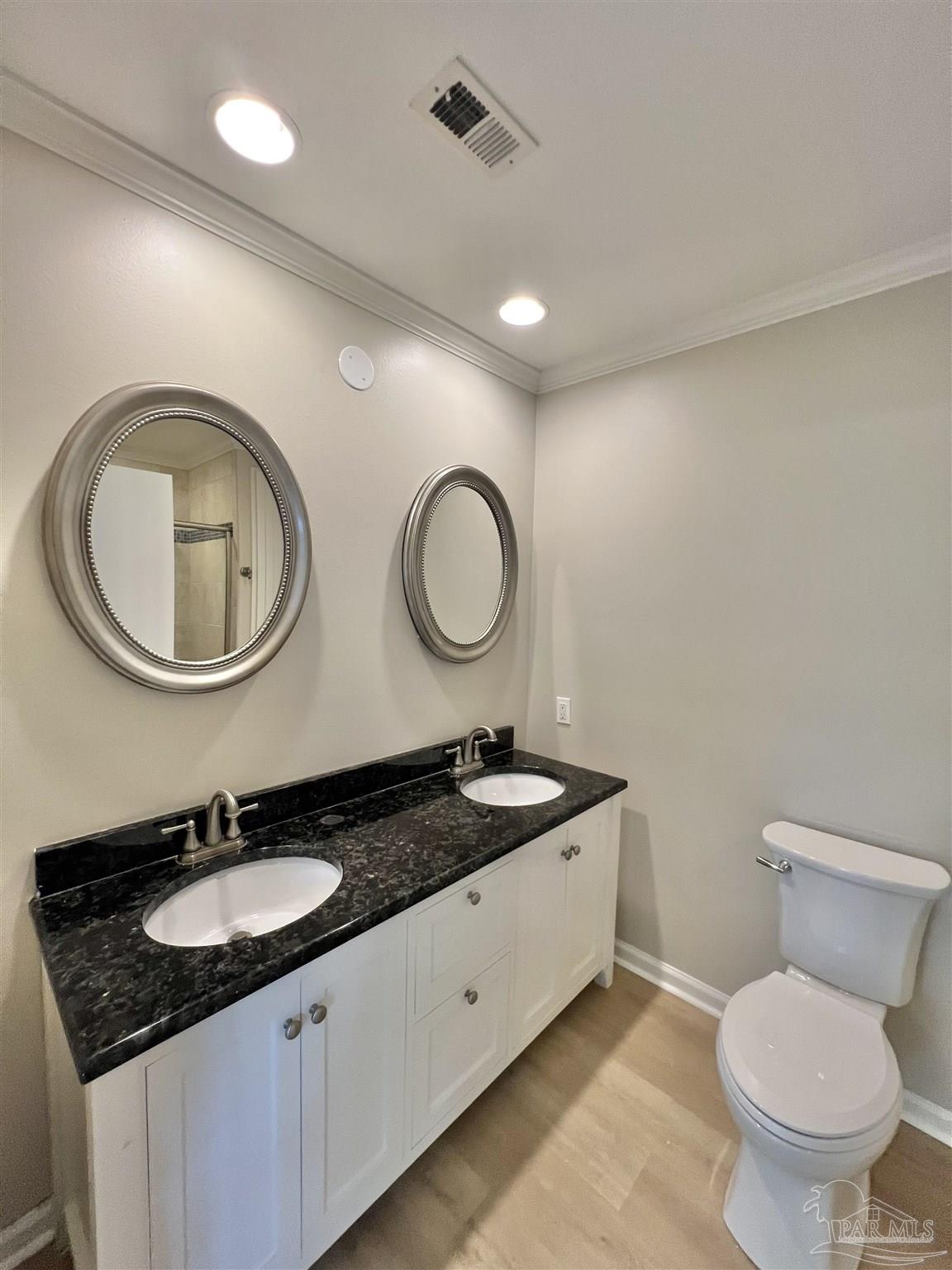 618 South Carney Street Atmore, AL 36502 - Photo 34 of 39 a bathroom with a granite countertop double sink and a mirror