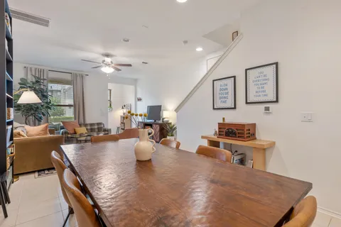 a living room with furniture a chandelier and a flat screen tv