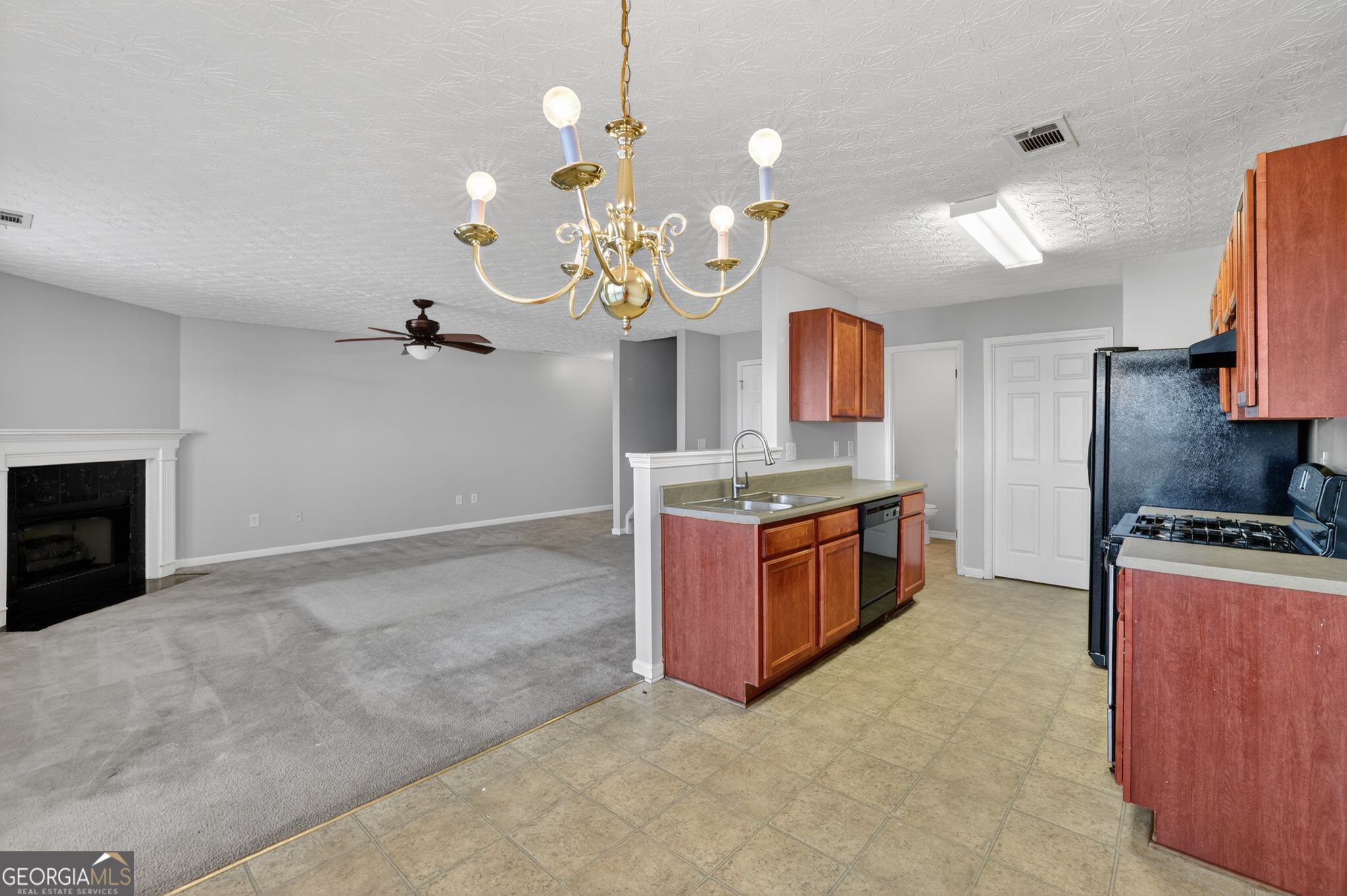 6256 Lake Valley Point Lithonia, GA 30058 - Photo 12 of 33 a large kitchen with kitchen island a stove a sink a center island and wooden floor