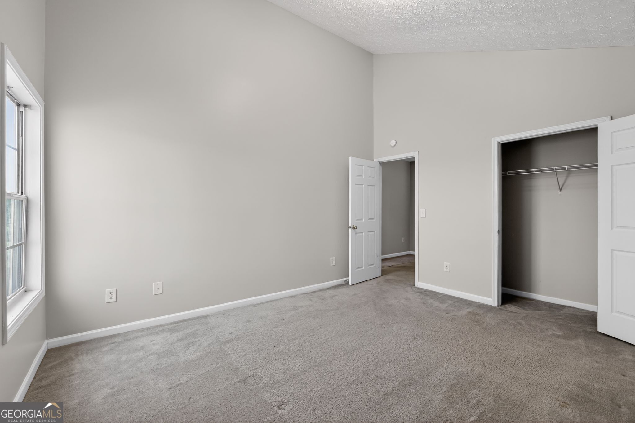 6256 Lake Valley Point Lithonia, GA 30058 - Photo 13 of 33 an empty room with closet and windows