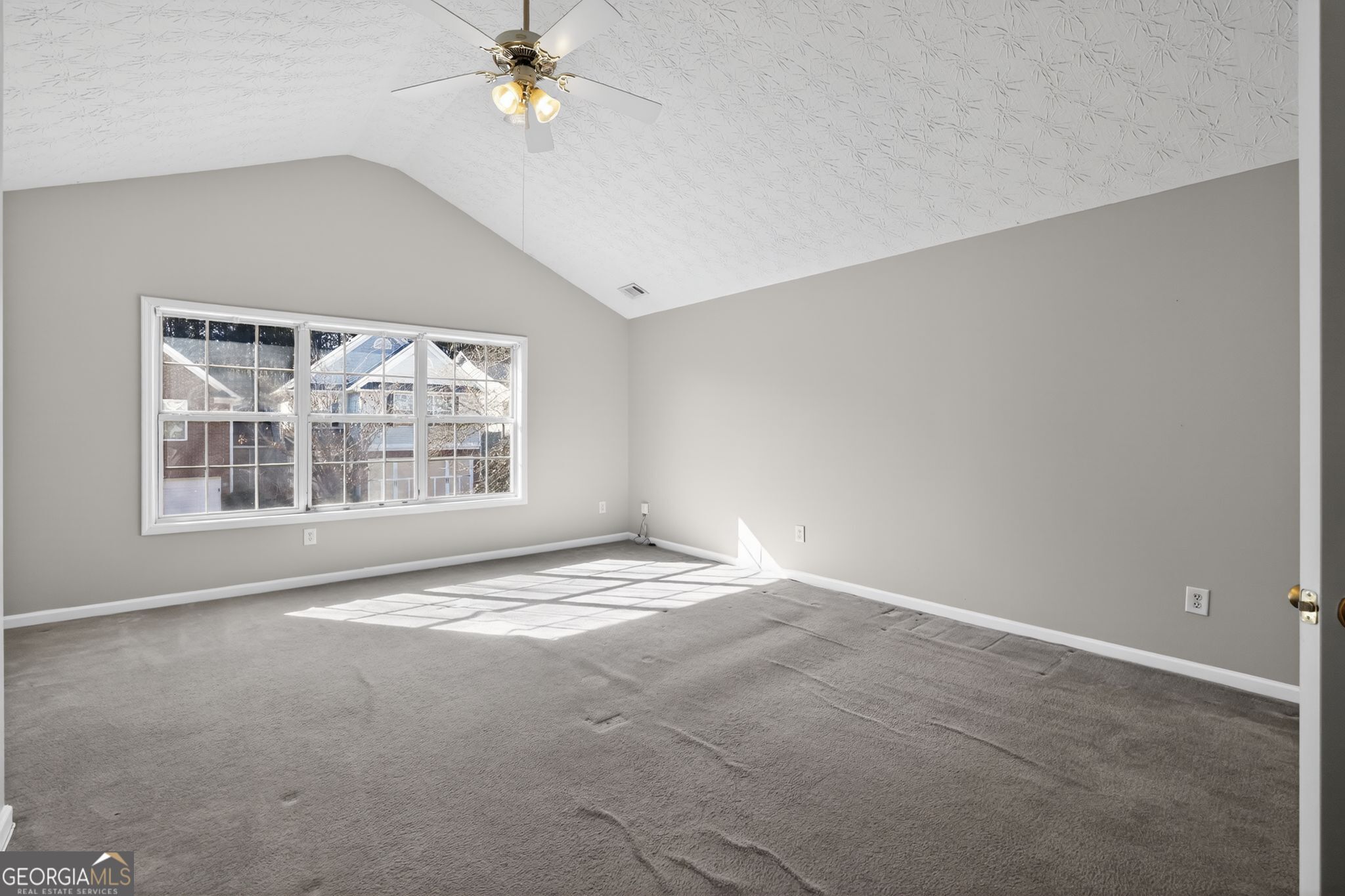 6256 Lake Valley Point Lithonia, GA 30058 - Photo 19 of 33 an empty room with windows and ceiling fan