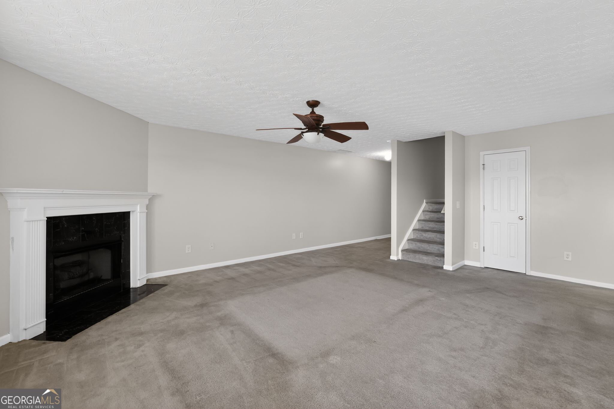 6256 Lake Valley Point Lithonia, GA 30058 - Photo 5 of 33 a view of an empty room with a fireplace and a window