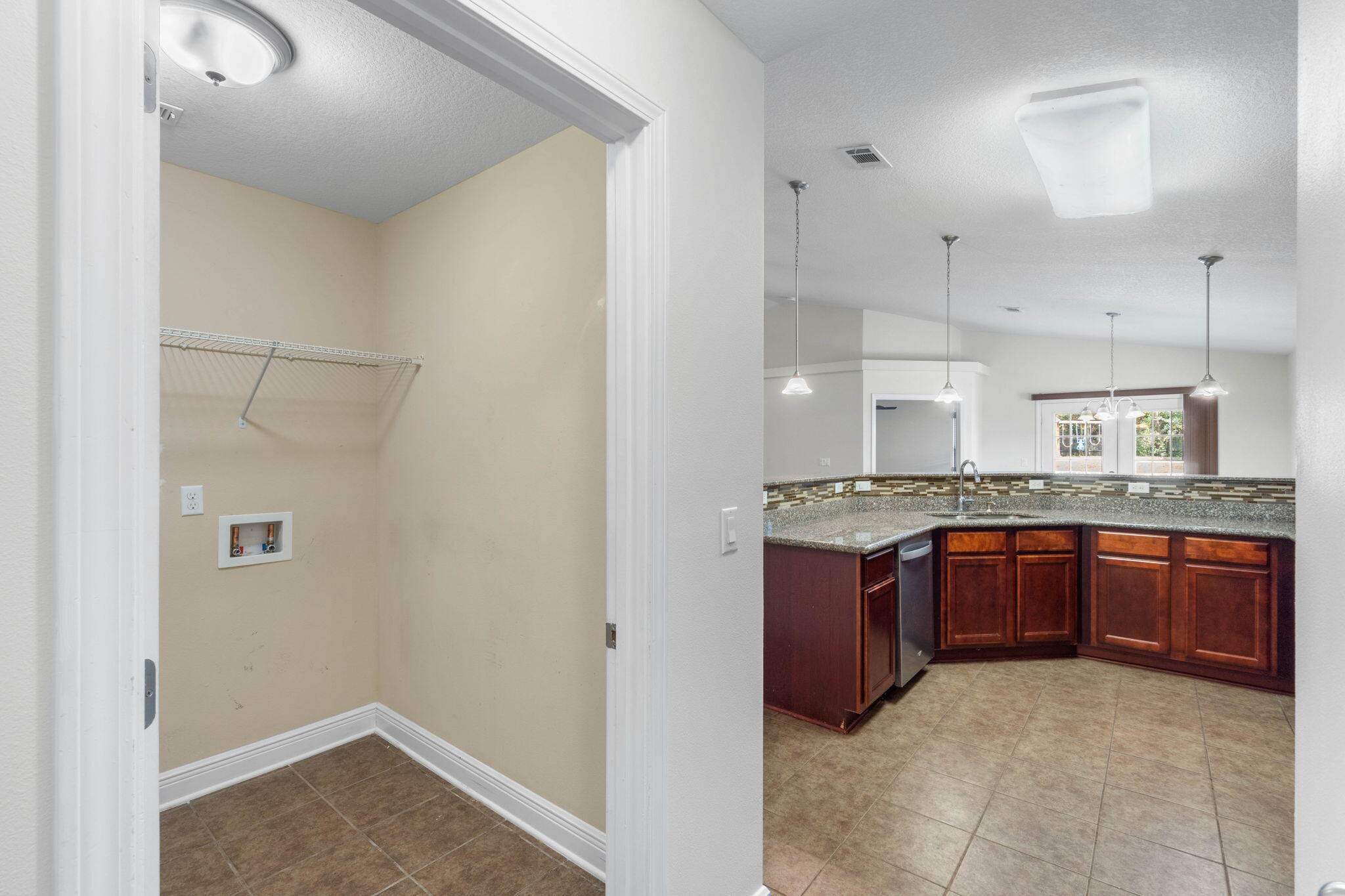 5609 Price Plantation Road Baker, FL 32531 - Photo 16 of 49 a kitchen with stainless steel appliances granite countertop a sink and cabinets