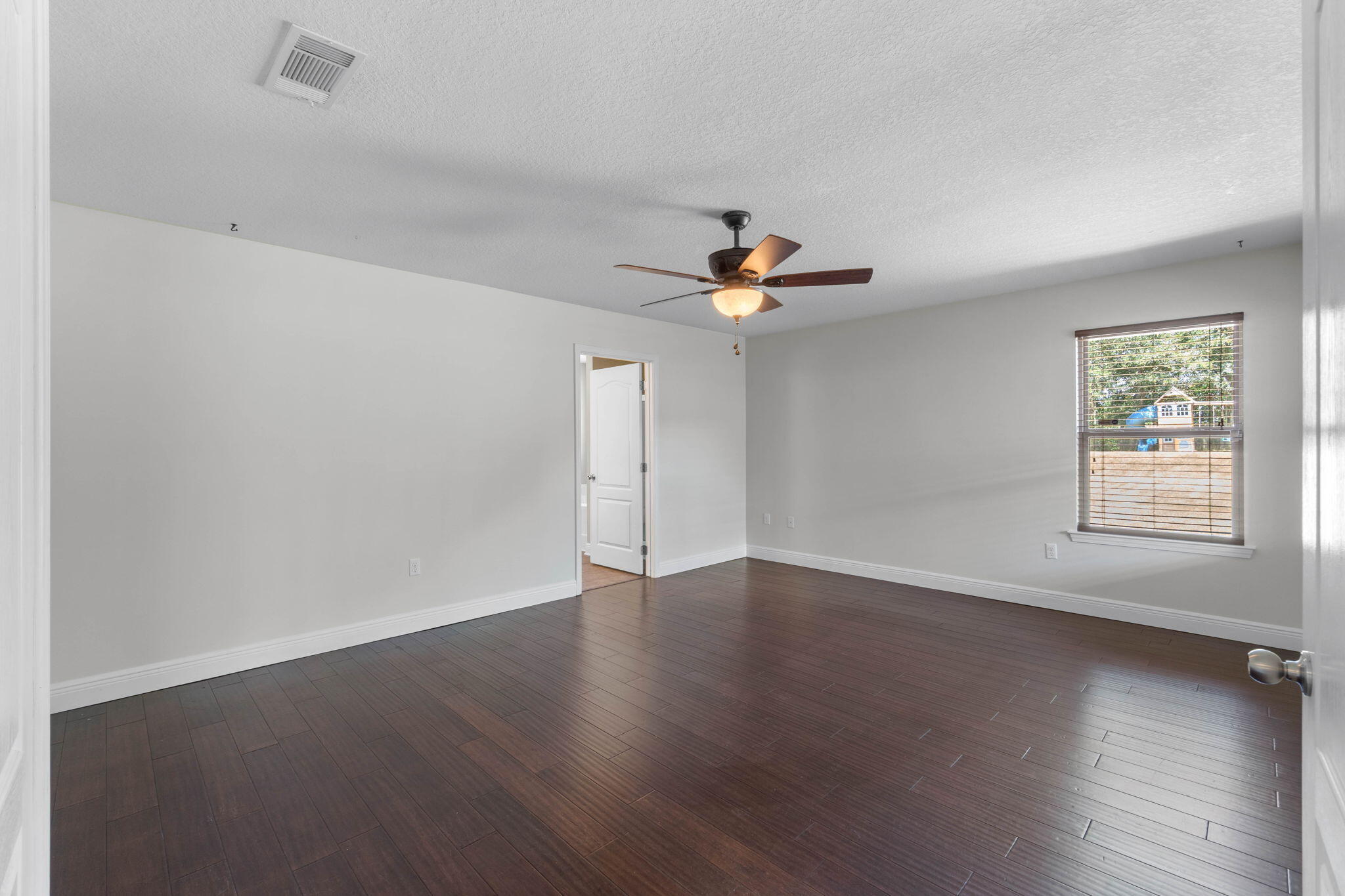 5609 Price Plantation Road Baker, FL 32531 - Photo 23 of 49 a view of an empty room with wooden floor and window