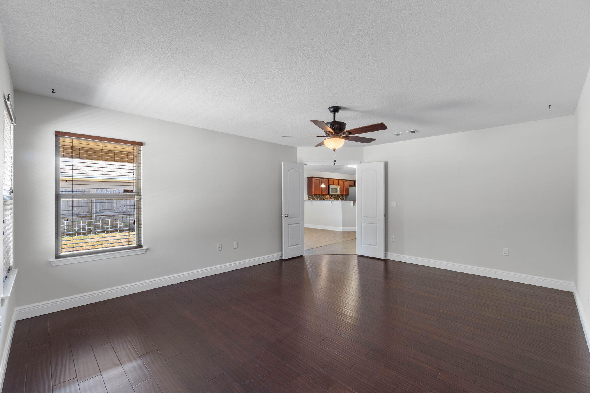 5609 Price Plantation Road Baker, FL 32531 - Photo 24 of 49 a view of an empty room with a window and wooden floor