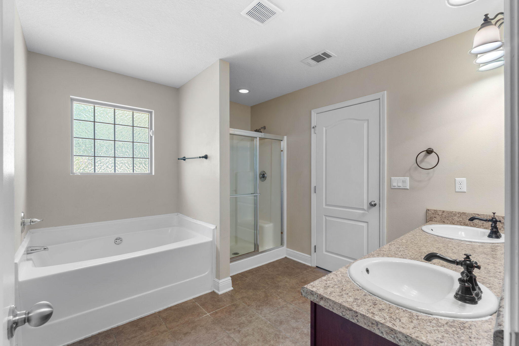 5609 Price Plantation Road Baker, FL 32531 - Photo 26 of 49 a bathroom with a granite countertop tub sink and mirror