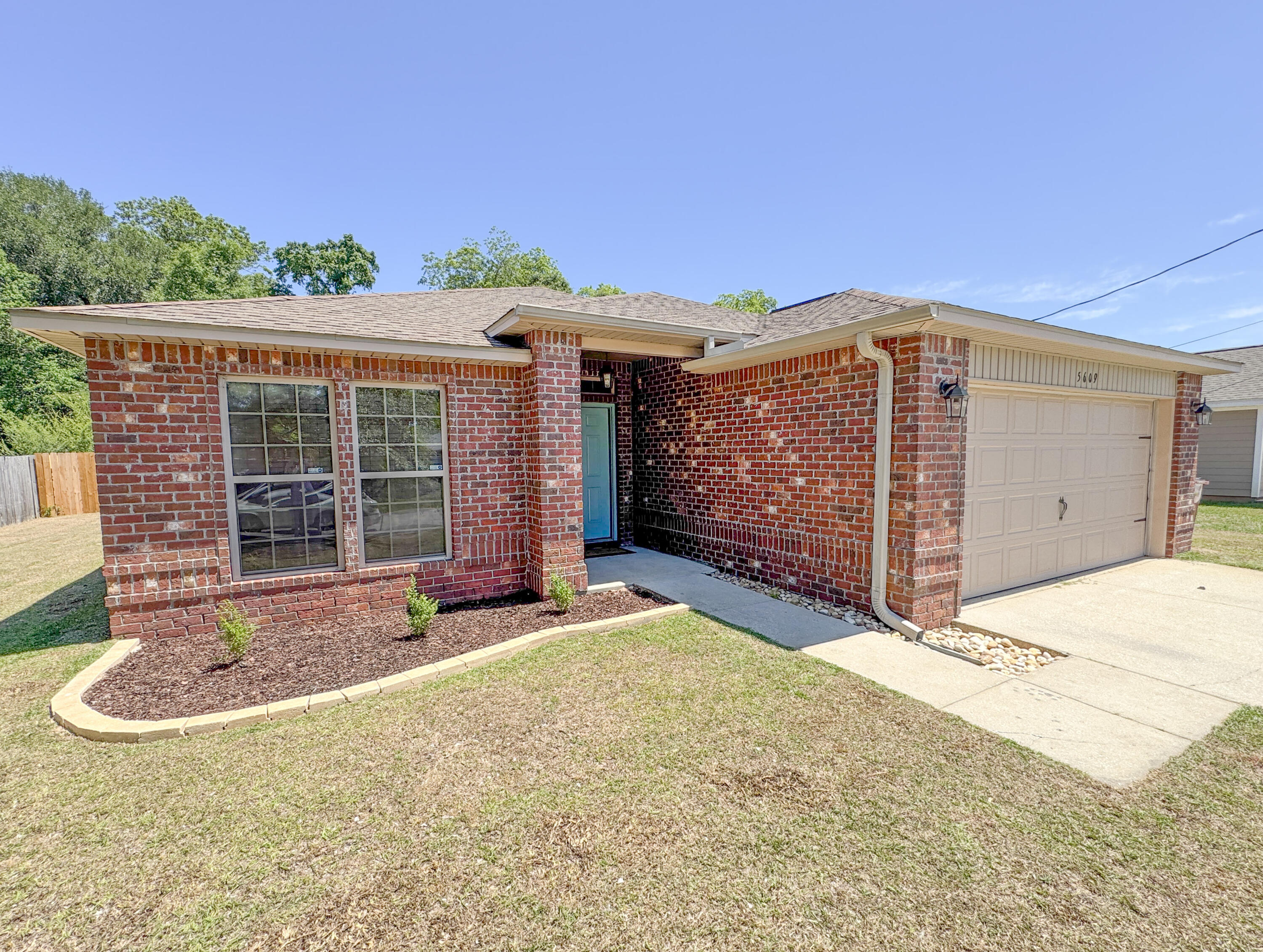 5609 Price Plantation Road Baker, FL 32531 - Photo 49 of 49 a front view of a house with a garage