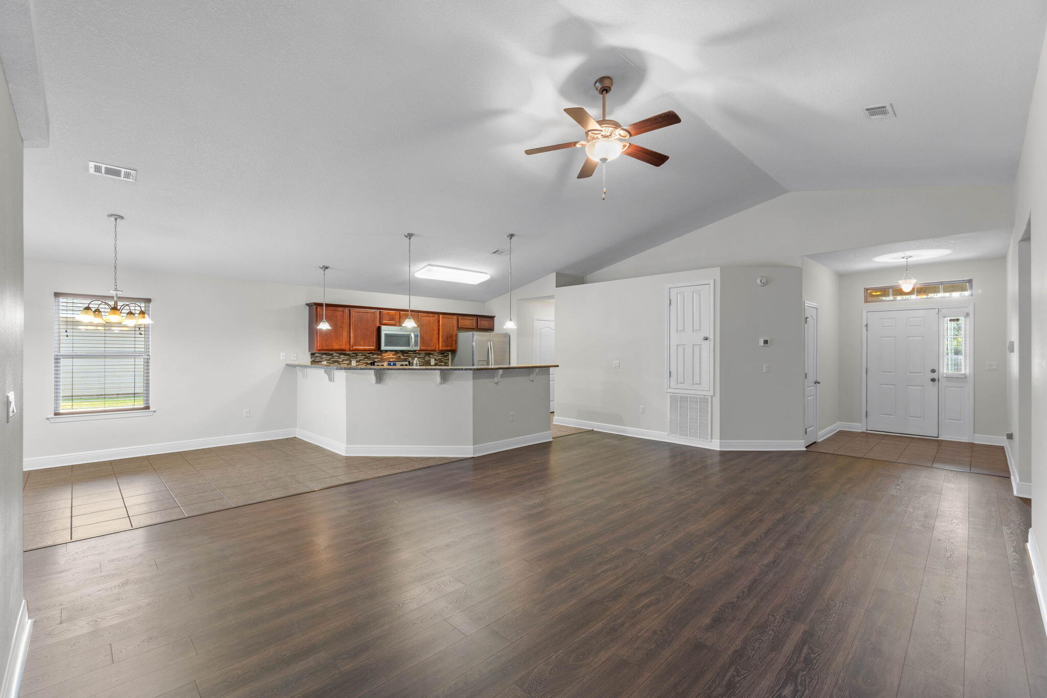 5609 Price Plantation Road Baker, FL 32531 - Photo 6 of 49 a view of an empty room with window and wooden floor