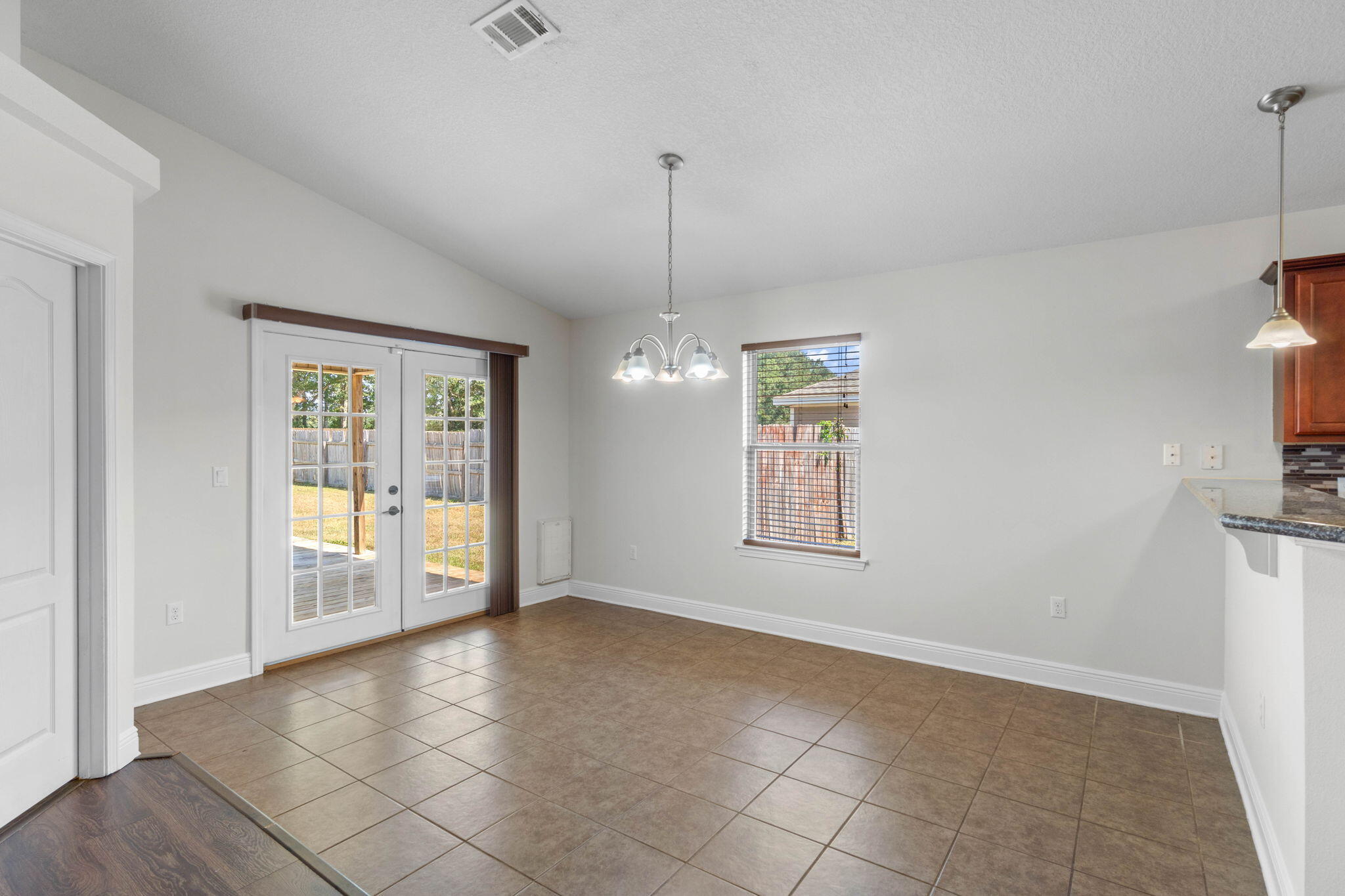 5609 Price Plantation Road Baker, FL 32531 - Photo 7 of 49 a view of an empty room with window and chandelier fan