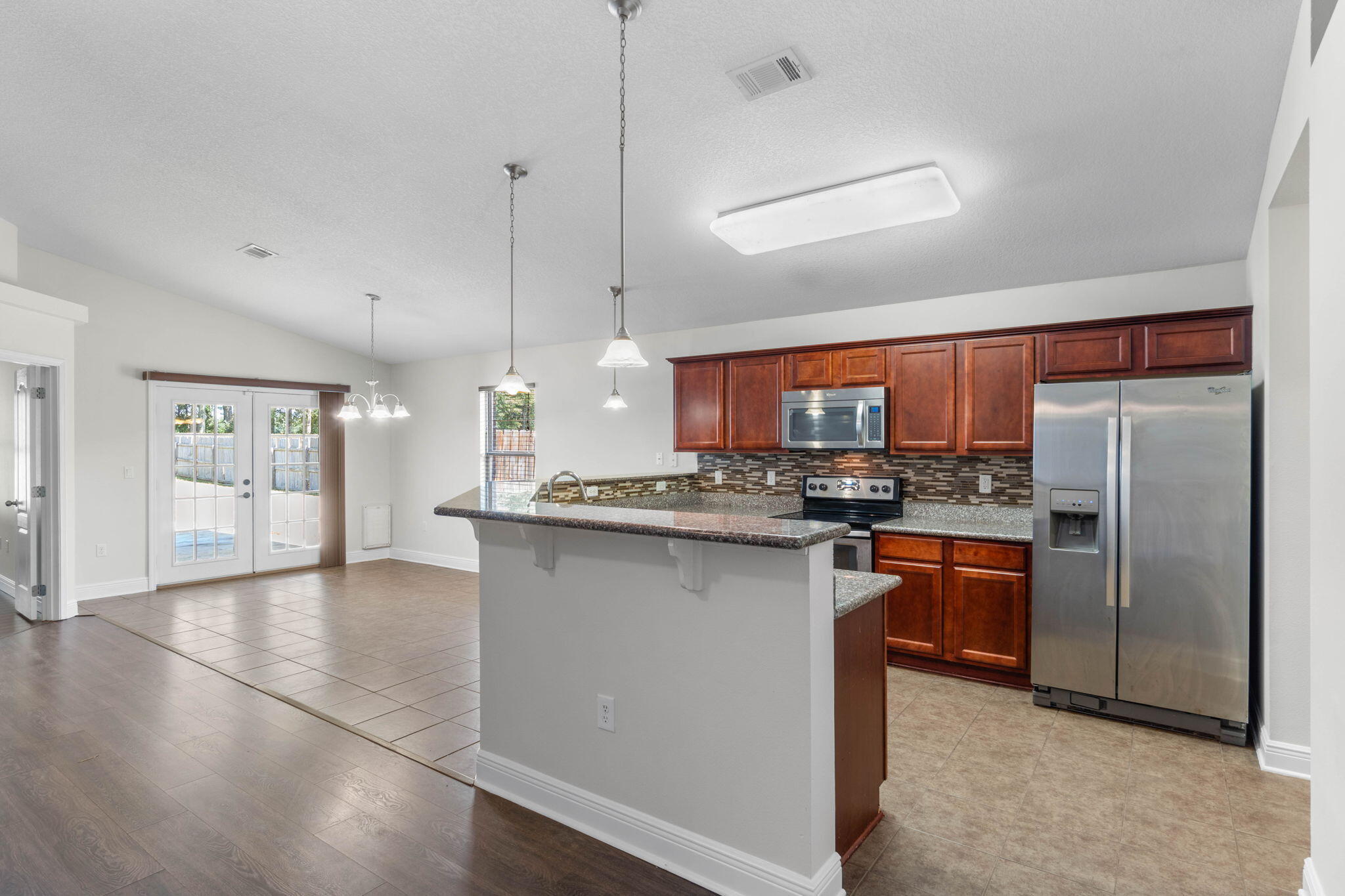 5609 Price Plantation Road Baker, FL 32531 - Photo 10 of 49 a kitchen with stainless steel appliances granite countertop a refrigerator a sink dishwasher a stove and a refrigerator