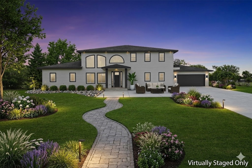 a front view of a house with a garden