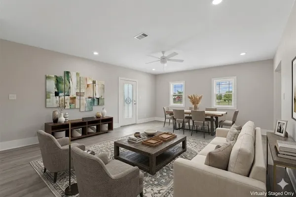 a living room with furniture and wooden floor
