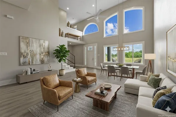 a living room with furniture ceiling fan and a window