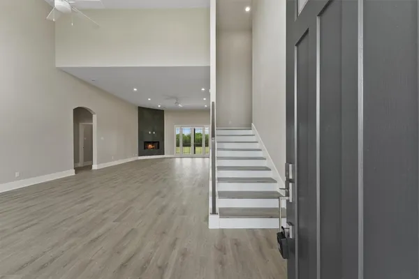 a view of a hallway with wooden floor and entryway